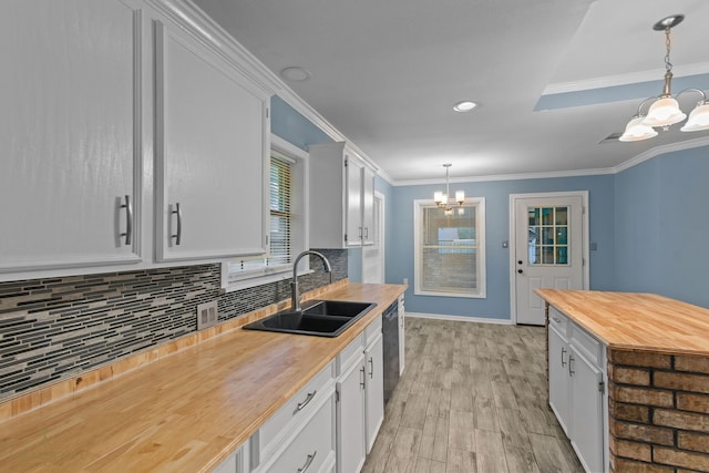 kitchen with white cabinetry, sink, and decorative light fixtures