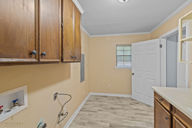 washroom with cabinets, ornamental molding, electric panel, hookup for a washing machine, and light wood-type flooring