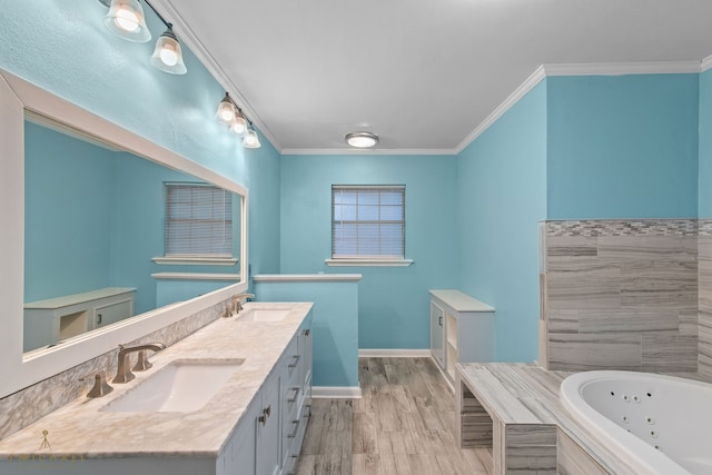 bathroom featuring ornamental molding, vanity, hardwood / wood-style flooring, and a bath