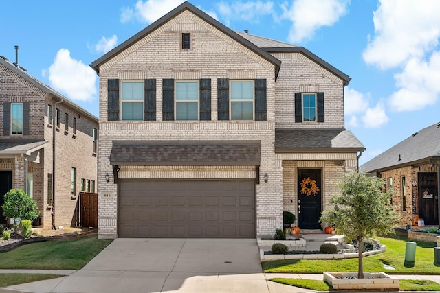 view of property with a front lawn and a garage