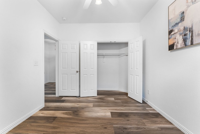 unfurnished bedroom with dark hardwood / wood-style flooring, ceiling fan, and a closet