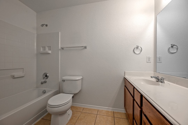 full bathroom featuring toilet, vanity, tile patterned floors, and tiled shower / bath