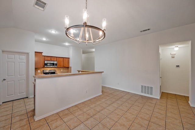 kitchen featuring stainless steel appliances, hanging light fixtures, light tile patterned flooring, and backsplash