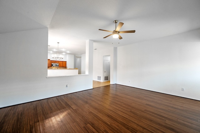 unfurnished living room with wood-type flooring and ceiling fan with notable chandelier