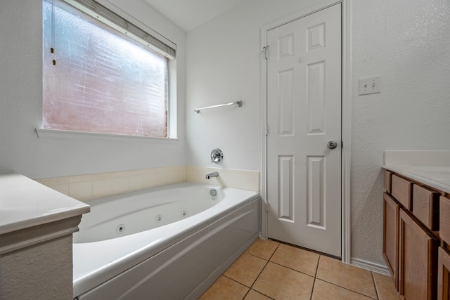 bathroom featuring a washtub, vanity, and tile patterned floors