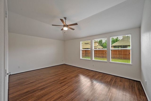 empty room featuring ceiling fan, lofted ceiling, and dark hardwood / wood-style floors