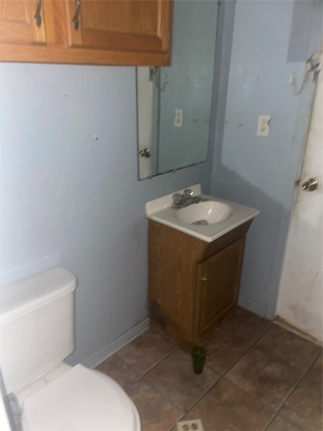 bathroom with vanity, tile patterned floors, and toilet