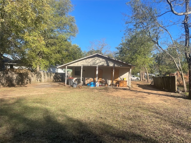 back of house featuring a lawn