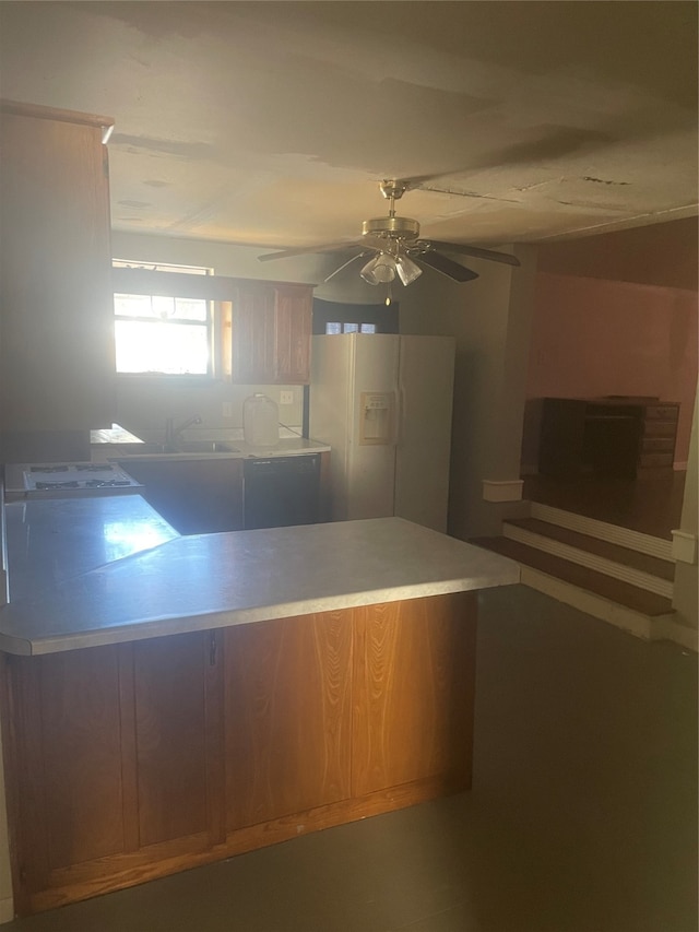 kitchen with ceiling fan, sink, and white fridge with ice dispenser