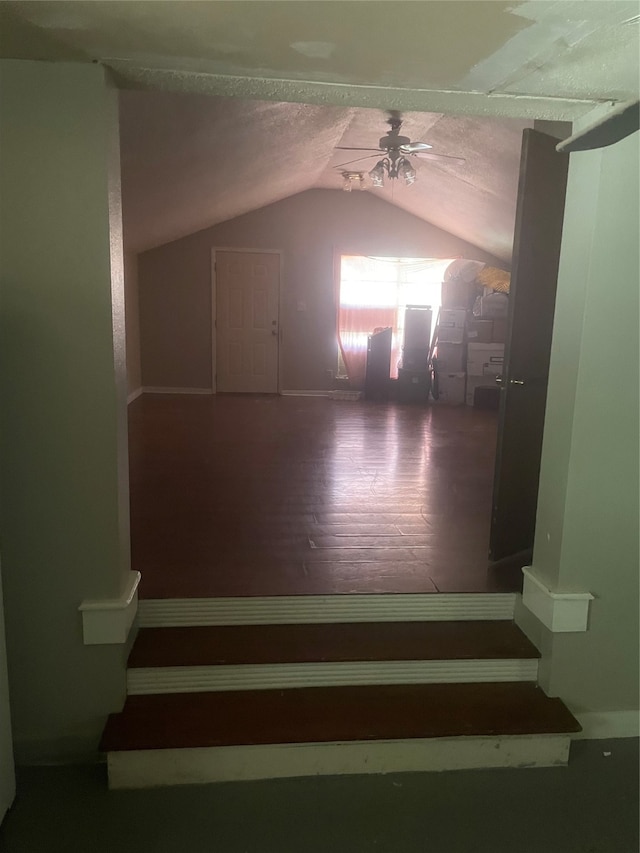 additional living space with wood-type flooring, vaulted ceiling, ceiling fan, and a textured ceiling