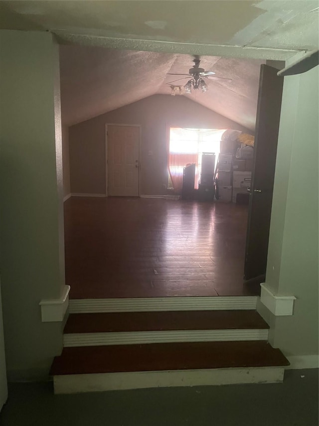844 1st St SW, Paris, TX 75460 - staircase with lofted ceiling, ceiling fan, wood finished floors, and baseboards