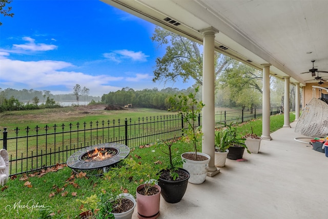 view of patio / terrace featuring a rural view, an outdoor fire pit, and ceiling fan