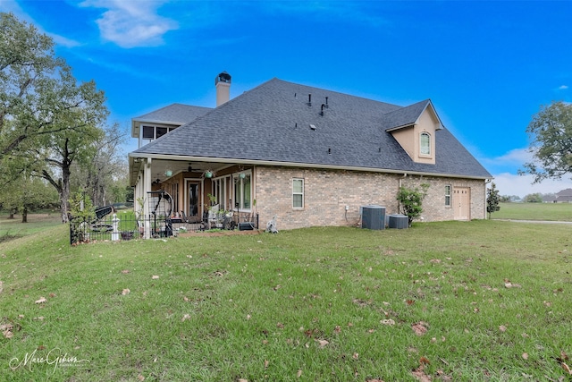 back of property featuring a patio, ceiling fan, cooling unit, and a yard