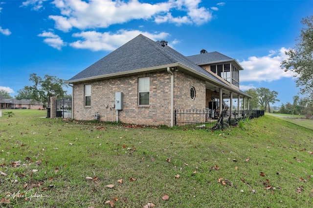 view of property exterior featuring a lawn and a balcony