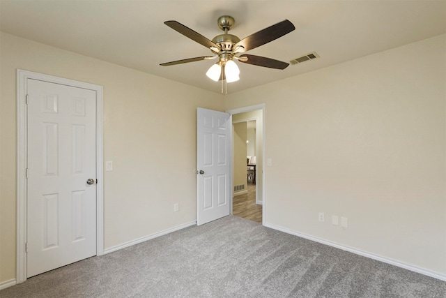 unfurnished bedroom featuring carpet and ceiling fan