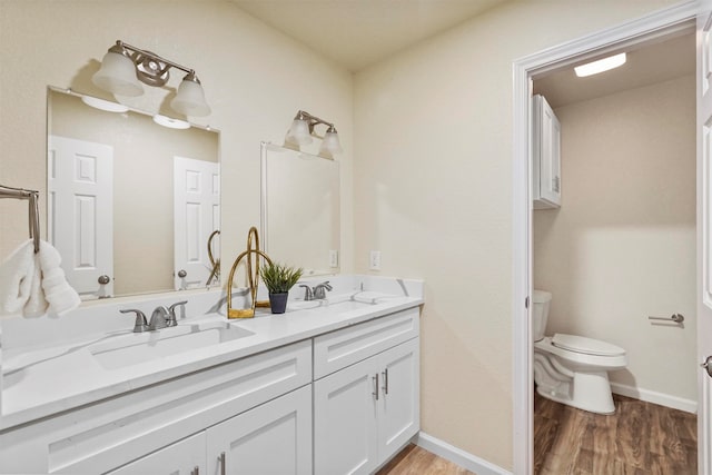 bathroom featuring vanity, hardwood / wood-style flooring, and toilet