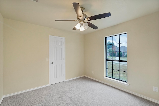 spare room featuring ceiling fan, plenty of natural light, and carpet flooring