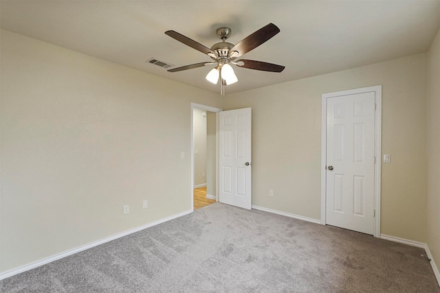 unfurnished bedroom featuring ceiling fan and light colored carpet