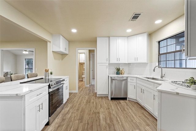 kitchen featuring white cabinetry, sink, and stainless steel appliances