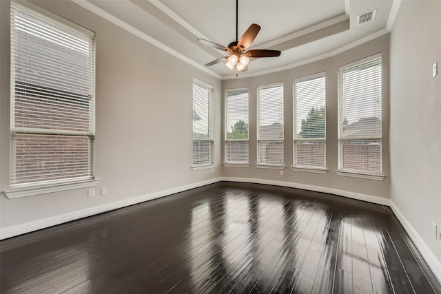 spare room featuring dark hardwood / wood-style flooring, ceiling fan, and crown molding