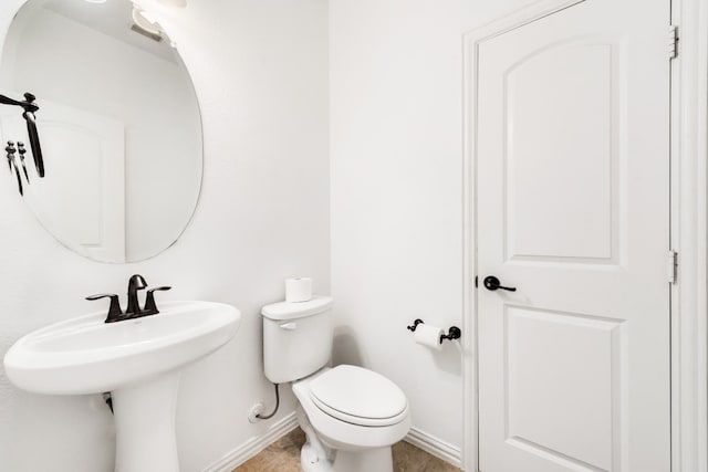 bathroom featuring tile patterned flooring and toilet