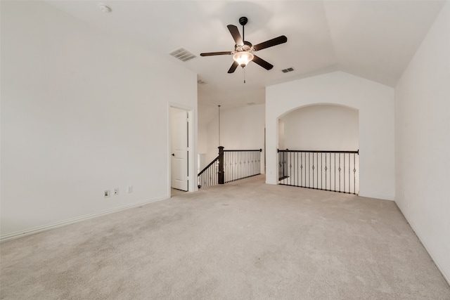 unfurnished room featuring light carpet, ceiling fan, and vaulted ceiling