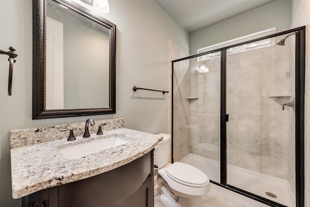 bathroom featuring walk in shower, vanity, and toilet