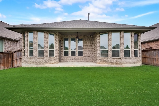 rear view of house with a patio area, a lawn, and ceiling fan