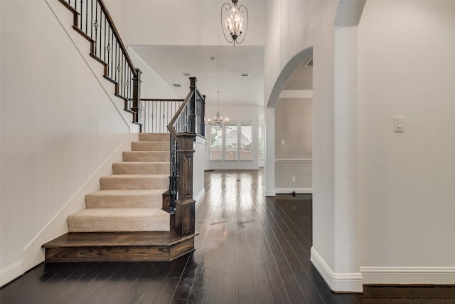 entrance foyer featuring dark hardwood / wood-style floors and an inviting chandelier