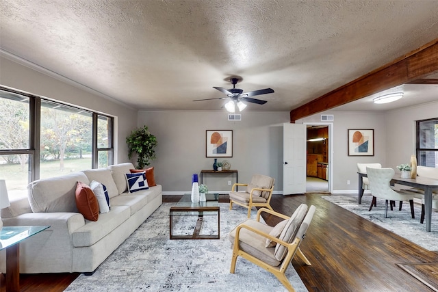 living room with hardwood / wood-style floors, ceiling fan, a textured ceiling, and crown molding