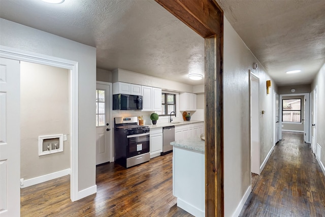 hall featuring dark wood-type flooring, a textured ceiling, and sink