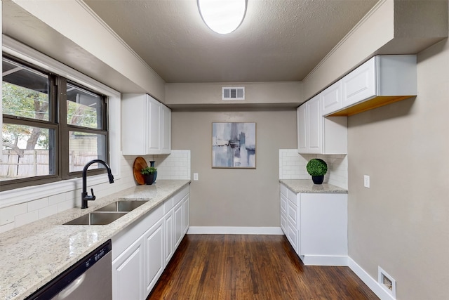 kitchen with backsplash, sink, and white cabinets