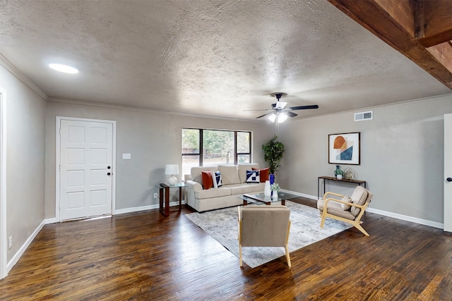 living room with ceiling fan, beamed ceiling, dark hardwood / wood-style floors, and a textured ceiling