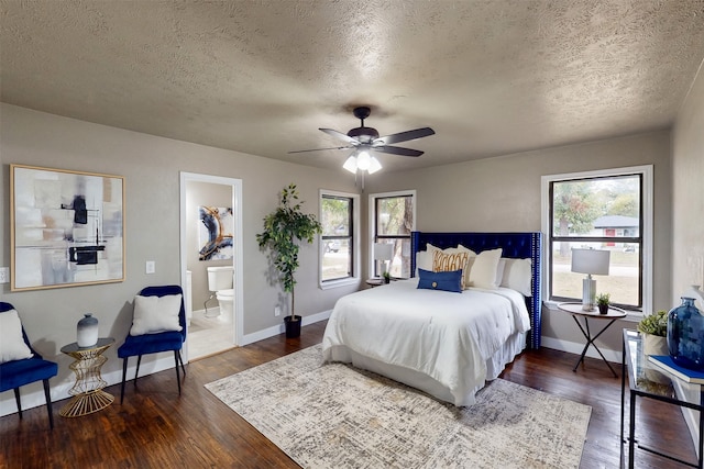 bedroom featuring a textured ceiling, dark wood-type flooring, multiple windows, and ceiling fan