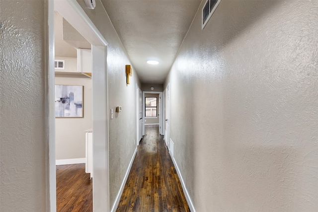 hallway with dark hardwood / wood-style floors