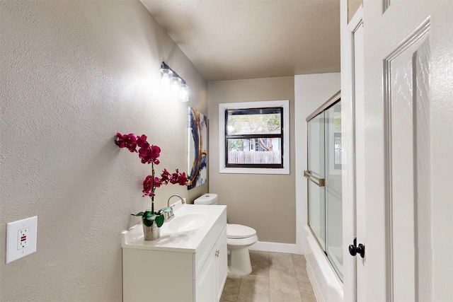 full bathroom featuring toilet, bath / shower combo with glass door, vanity, and tile patterned floors