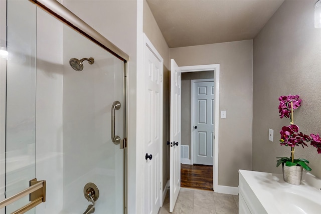 bathroom featuring hardwood / wood-style floors and a shower with shower door