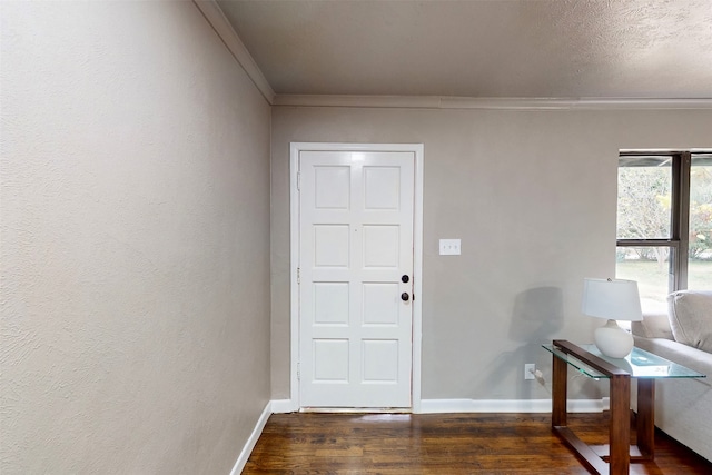 entrance foyer with dark hardwood / wood-style floors and crown molding