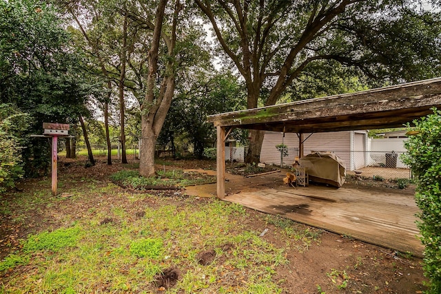 view of yard with a carport and a deck