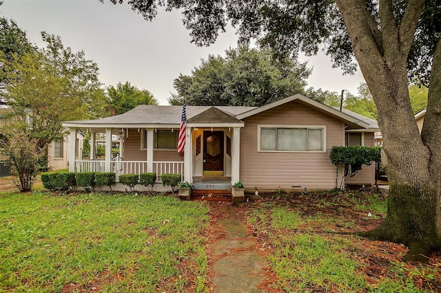 ranch-style home featuring a front yard and a porch