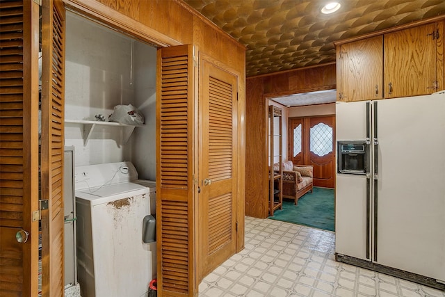 washroom featuring wood walls and washer / dryer