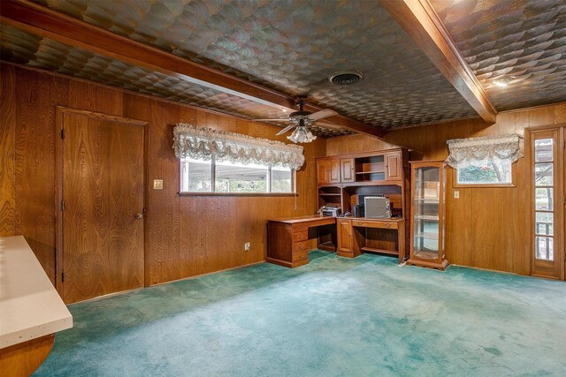 unfurnished office featuring beamed ceiling and wooden walls