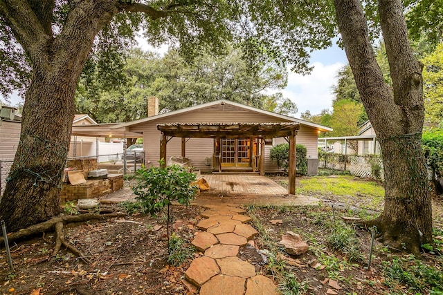 view of yard with an outdoor kitchen, a wooden deck, and a pergola