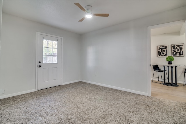 empty room featuring light colored carpet and ceiling fan