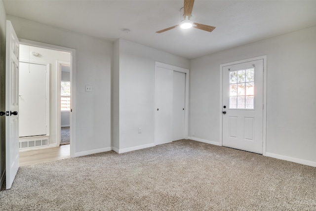 interior space with ceiling fan