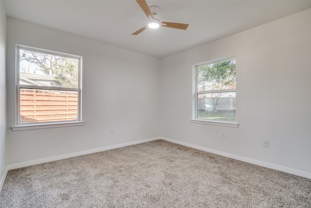 spare room featuring carpet, ceiling fan, and a healthy amount of sunlight