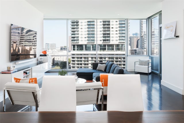 living room featuring expansive windows, a wealth of natural light, and wood-type flooring