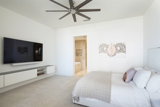 bedroom with ensuite bathroom, ceiling fan, and light carpet