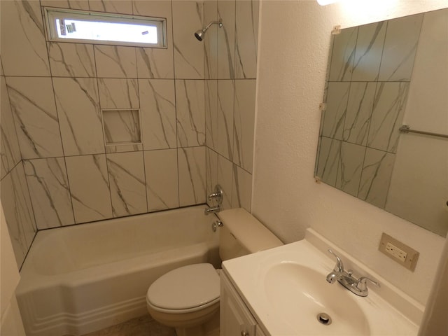 full bathroom featuring vanity, tiled shower / bath combo, and toilet