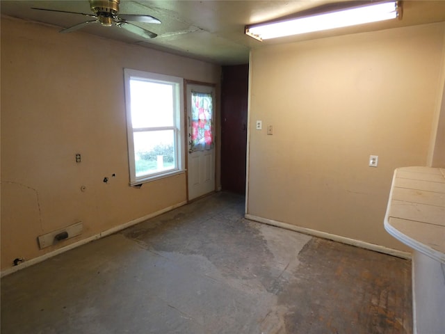 unfurnished room with concrete floors and ceiling fan